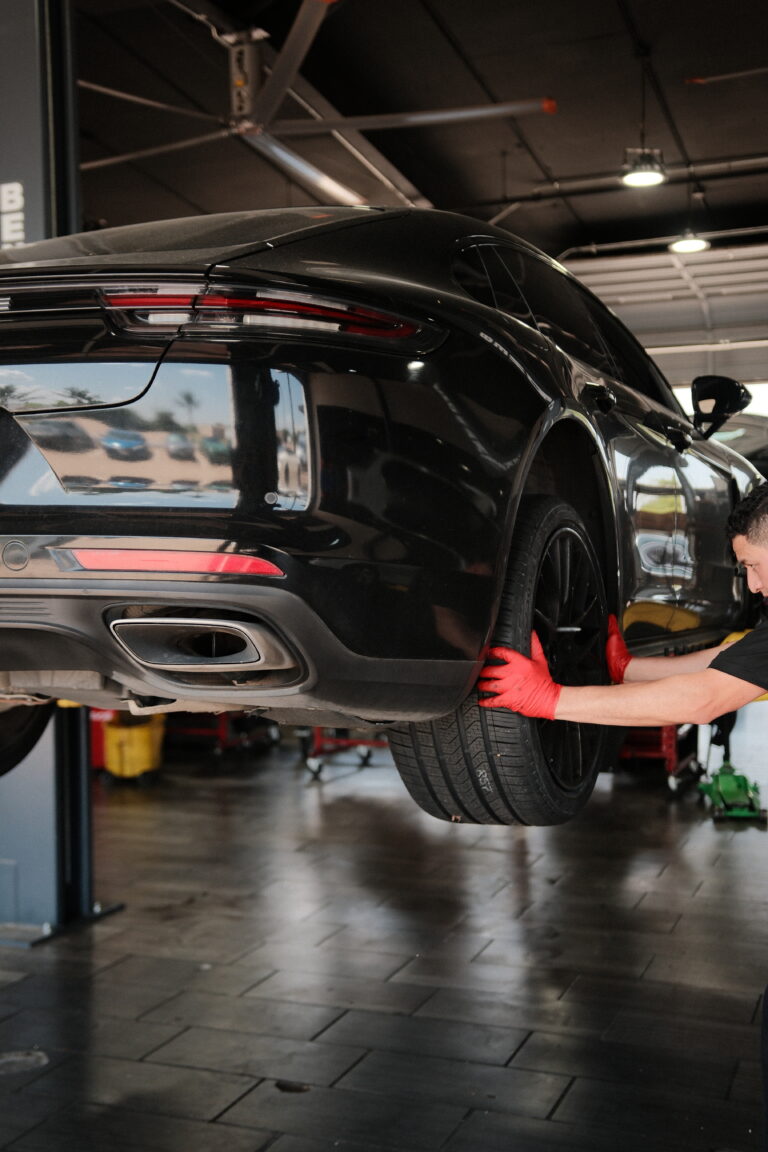 Black Mercedes-Benz on a lift in the JP Euro service bay in Garland, TX